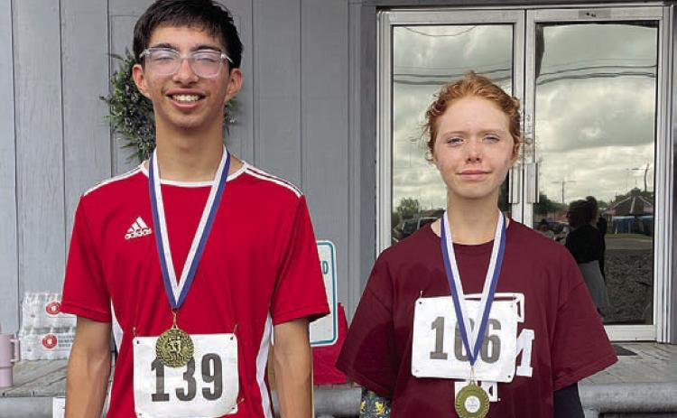 Fastest runners – Keegan Escamilla (left) of Columbus, fastest overall with a time of 18:59, and Judy Ashlynd (right), fastest female with a time of 25:05.