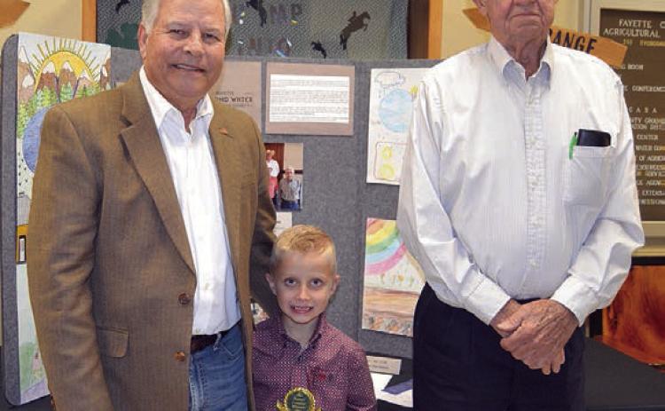 POSTE R CONTE ST – Division 1 (Grades K-2) Winners: Carter Ahrens of Flatonia Elementary (center) and Byrlinn Marrs of Flatonia Elementary (not shown) Presenters: Gene Kruppa (left) and Norman Schultz (right) representing Colorado Valley Communications