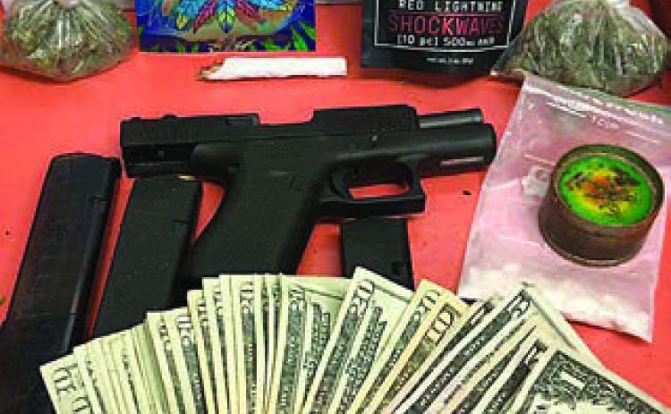 Shown above are the drugs, firearms, and cash recovered by the SPD after a traffic stop that resulted in the arrest of a 25-year-old La Grange man.