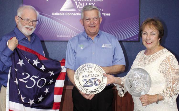 To celebrate America’s 250th birthday, 250 “Liberty Trees” will be planted this fall all across the county. Colorado Valley Communications is the first Gold Sponsor for the project. Larry Jackson (left), project chair, and Karen Mahoney-Woods (right), project secretary, present CVCTX President/General Manager Kelly Allison with a Liberty Tree commemorative medallion.