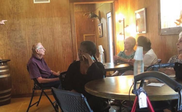Whistling Duck Winery near Weimar was the destination of a NVCC day trip on Thursday, May 12. John Cook (left), owner, gave the history of the winery and also talked about the grape vines and their care.