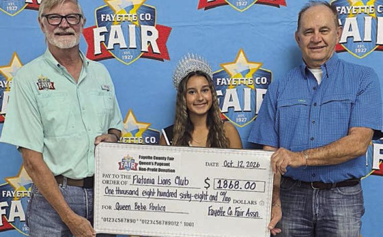 Flatonia Lions Club – Fair president Michael Zuhn (left) presents a donation of $1868 to the Flatonia Lions Club, represented by David Urban (right), with Queen Bebe Pavlica (center).
