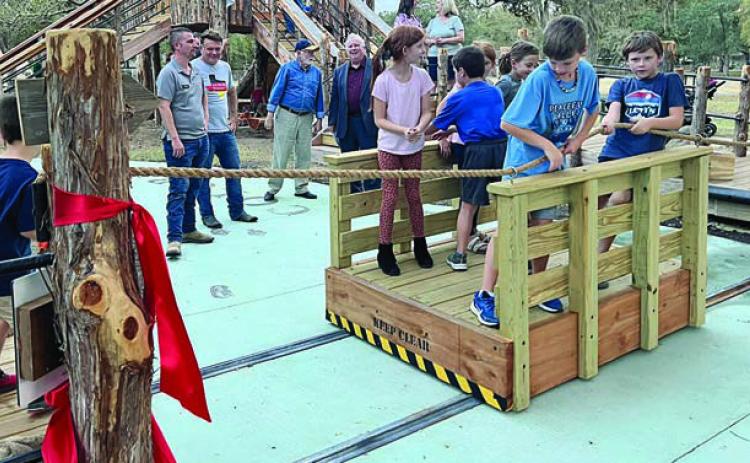 the Kreische ferry is being used by children to cross the “Colorado River” on the educational playscape.