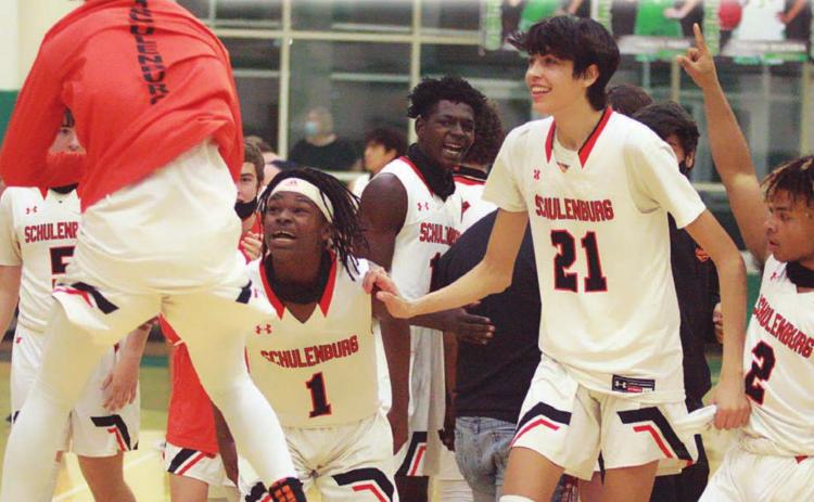 Bryce Wilson (left) jumps for joy as he celebrates Friday’s Class 2A Region IV final win over Port Aransas with teammates Kenny King (No. 1), Alex Lozano (No. 21), and Keisean Johnson (No. 2). Sticker Photo By Layne Vyvjala