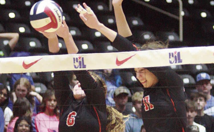 Tamara Otto (left) and Meredith Magliolo team up for a block in the first set. Sticker Photo By Layne Vyvjala