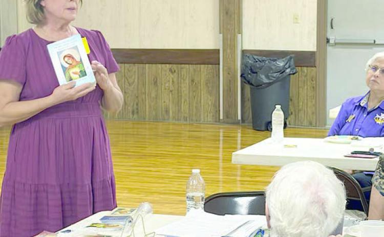 “Flame of Lo ve” was the topic of the program presented by Diane Holub (left) to the Catholic Daughters.