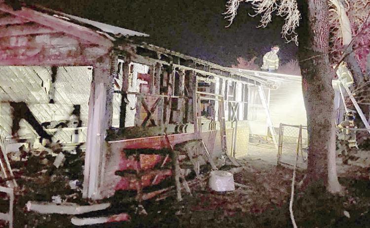 Firefighters continue to work in the early morning hours of Jan. 21 after a fire gutted the garage at the intersection of Bohlmann Avenue and Baumgarten Street. Photo Courtesy of SVFD
