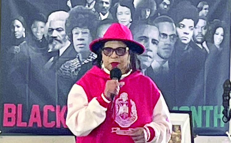 Dr. Virginia Glass Berry, with a backdrop of the most influential African-Americans in the country’s history, gives the keynote address at Saturday’s Black History Month Celebration. Sticker Photo By Darrell Vyvjala