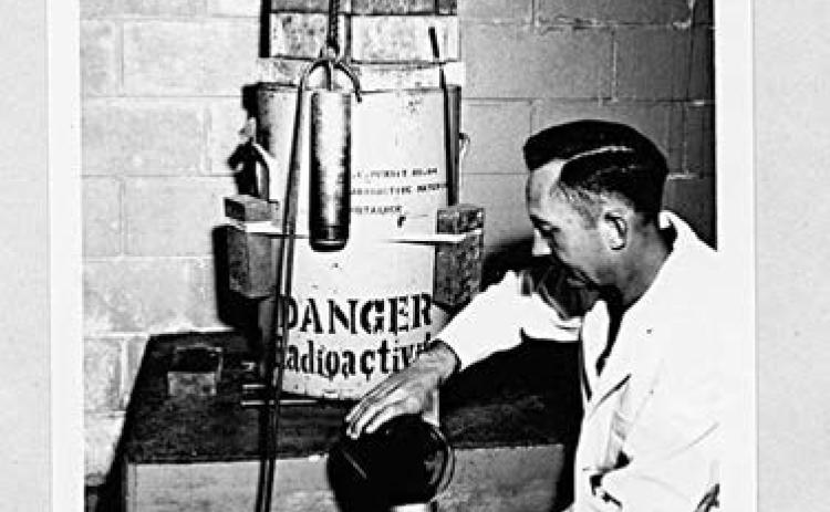 Entomology Research Branch, InsectsAffecting Man and Animals Section, Agricultural Research Service, United States Department of Agriculture. Photograph “Loading an Irradiation Chamber with Screw-Worm Pupae.” Special Collections, USDA National Agricultural Library. Accessed June 13, 2026, https://www.nal. usda.gov/exhibits/speccoll/items/show/7333.