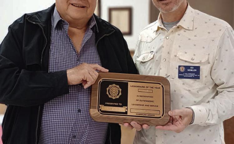 Post 143 Adjutant Dennis Muhlstein (left) accepts the Legionnaire of the Year award from First Vice Commander Ed Semler.