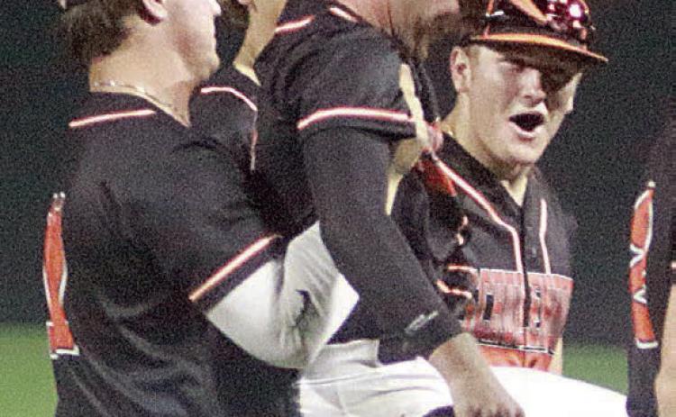 Winning pitcher Brycen Schramek get a hoist from Tyson Wagner as elated teammates surround them following the final out last Friday night. Sticker Photo By Darrell Vyvjala