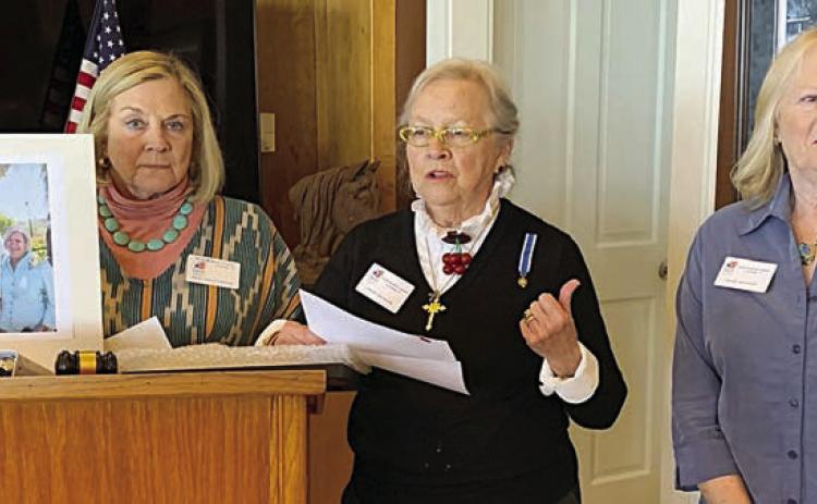 Kathy Aydellote was unable to be present to receive the Community Service Award from the Smith McMillan Chapter NSDAR. Shown accepting on her behalf are (from left) Kathryn Callaway, holding a portrait of Kathy Aydelotte and husband Eldon; Sally Reynolds, Community Service Awards chair; and Janet Murphy.