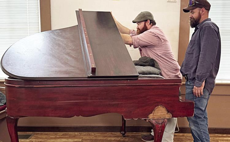 The M. Welte & Sons baby grand piano was delivered and is being tuned and restored by brothers Marquis Burkham and Quinton Burkham (pictured) of Plum Piano Restoration Company of La Grange.