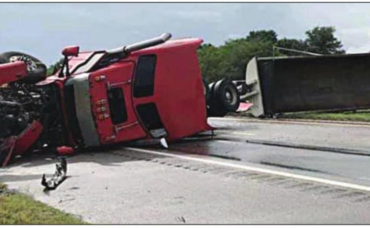 At left: The separated tractor-trailer blocks I-10 eastbound after overturning last Tuesday, July 28. Photos Courtesy of Schulenburg VFD