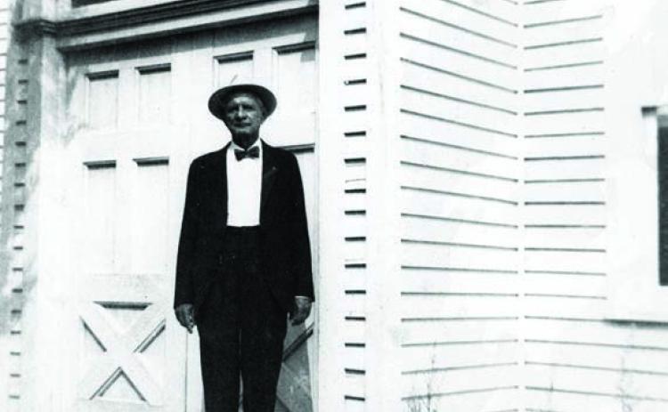 Charles Peter Luck in his later years, standing on the front steps of the Trinity Lutheran Church at Black Jack Springs. Courtesy of Fayette Heritage Museum &amp; Archives
