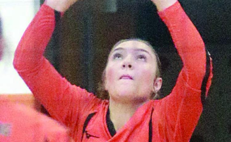Greenli VanZandt reaches up save a deflected Lady Tiger attack in third set last Tuesday. Sticker Photo By Darrell Vyvjala