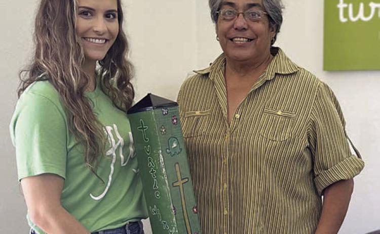 A special garden pole was presented to Turtle Wing Foundation, with Destiny Pescik (left), executive director, accepting the gift from Cindy Villarreal (right), Senior Connections executive director.
