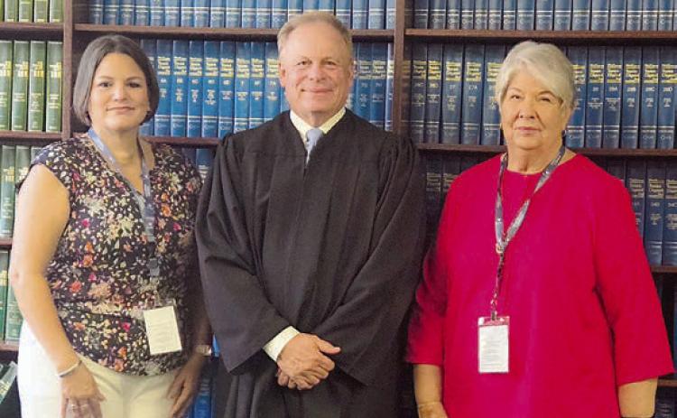 CASA of Bastrop, Fayette & Lee Counties welcomed two new volunteers when Tiffany Miller (left) and Nancy Walters (right) were sworn in by Benton Eskew (center), county court at law judge in Bastrop County