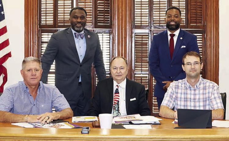 Commemorating the new collaboration between Prairie View A&amp;M University Extension Office and Fayette County are: (front, from left) Precinct 4 Commissioner Drew Brossmann, Precinct 3 Commissioner Harvey Berckenhoff, County Judge Dan Mueller, Precinct 2 Commissioner Clint Sternadel, Precinct 1 Commissioner Jason McBroom; (back, from left) Extension Agent Ronnie McDonald, and Assistant Program Leader Natriez Peterson. Photo By Melanie Berger / Courtesy of Flatonia Argus