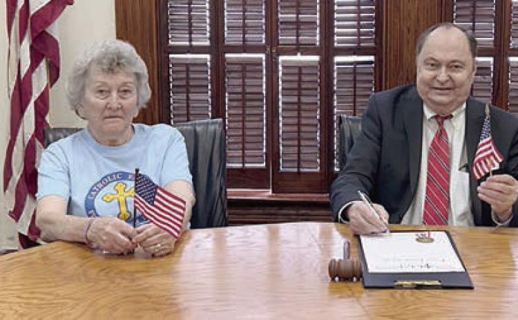 Members of KJZT Family Life, Hostyn Society No. 23, attended the signing of a proclamation setting aside June 14 as National Flag Day. Shown are (from left) Lorenda Polasek, Society No. 23 member; Helen Janda, Society No. 23 treasurer; Fayette County Judge Dan Mueller, who signed the document; and Lillian Kallus, Society No. 23 president.