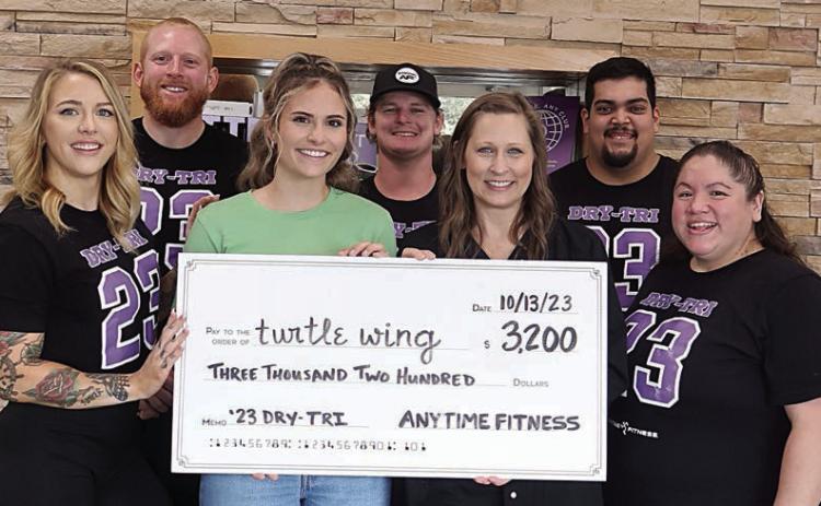 $3,200 check presented – The Dry-Tri held by Anytime Fitness raised $3,200 which was donated to Turtle Wing Foundation. On hand for the check presentation were (front row, from left) Lauren Ralph, Anytime Fitness; Destiny Psencik and DeeAnn Hooper, Turtle Wing Foundation; Amanda Brown, Anytime Fitness; (back) Mitchell Martin Bailey, Reyden Svatek and Abraham Centeno, Anytime Fitness.