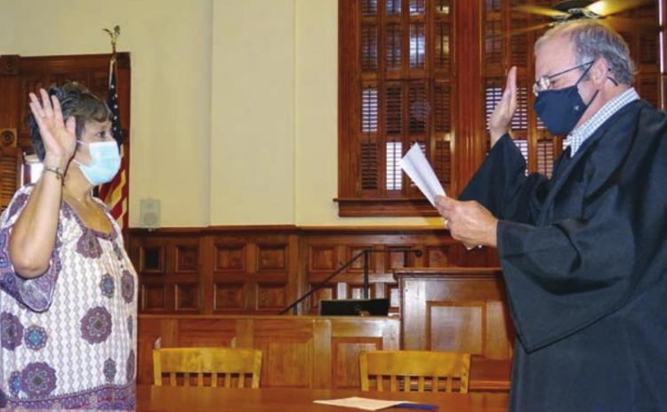 In a special ceremony held in the District Courtroom of the Fayette County Courthouse on Friday morning, Sept. 11, Sylvia Mendoza (left) was sworn in as the interim Fayette County Tax Assessor-Collector by Fayette County Judge Joe Weber (right). Photo By Melanie Berger / Courtesy of Flatonia Argus