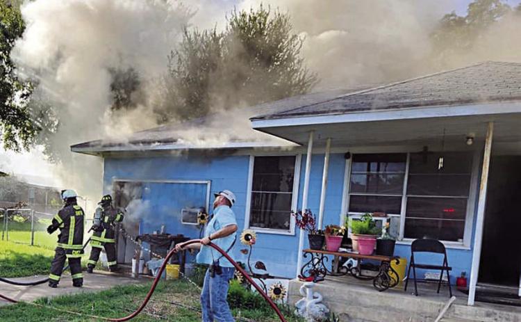 SVFD firefighters battle the house fire in the 100 block of Baumgarten Street last Wednesday. Photo Courtesy of the SVFD