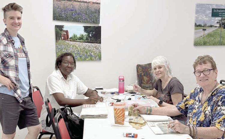 In her Artful Friday class, Jaime Janda (left) consults with some of the creative ladies.Working on their art journals are (continuing from left) Deborah Jones, Kim Penland and Berni Gillings. Each of their individual creations is a work of art.