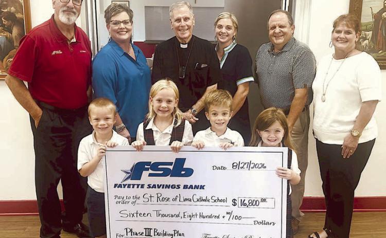 On hand as a $16,800 check was presented by Fayette Savings Bank to the St. Rose of Lima Catholic School Phase III Building Project were (front row, from left) St. Rose students Waylon Neskora, Paisley Guentert, Henry Neskora and Drew Schneider; (back row) Mike Olle and Cheryl Brossmann, FSB and personal donors; Fr. Jasper Liggio, St. Rose pastor; Taylor Jensen St. Rose School principal; and Rodney Kalich and Darlene Brothers, FSB and personal donors.