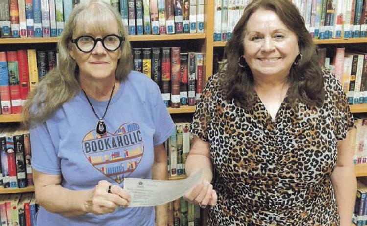 A $6,000 grant from the Tocker Foundation is displayed by Schulenburg Public Library librarians (from left) Cindy Lytle and Donna Holub.