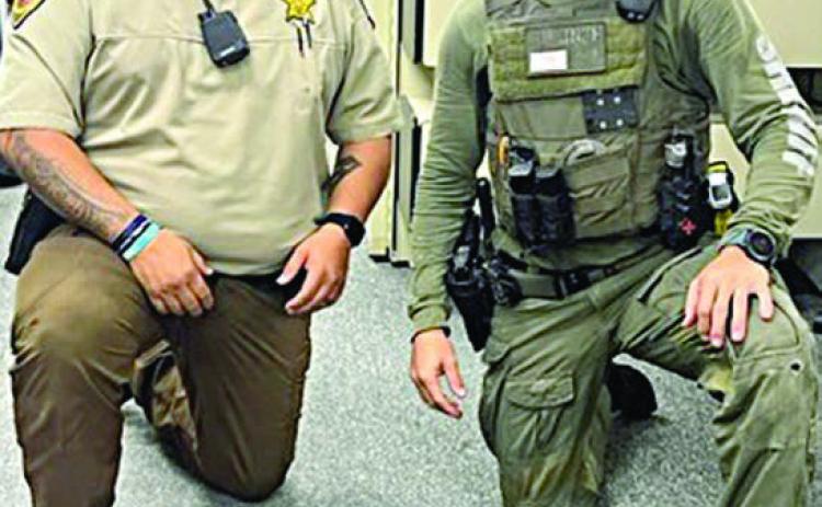 Deputy Herman Olvera (left) and Drug Interdiction Investigator David Smith (right) are pictured with the $191,000 in U.S. currency seized after a traffic stop on Interstate 10.