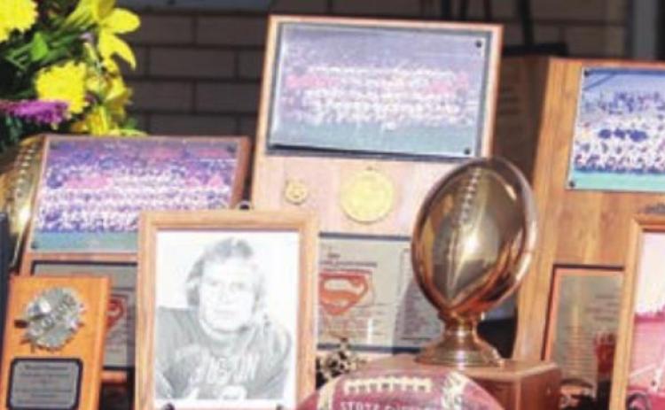 A display outside the gym included trophies, photos, and memorabilia from coach Husmann’s days at the University of Houston as well as his coaching career. Sticker Photo By Darrell Vyvjala