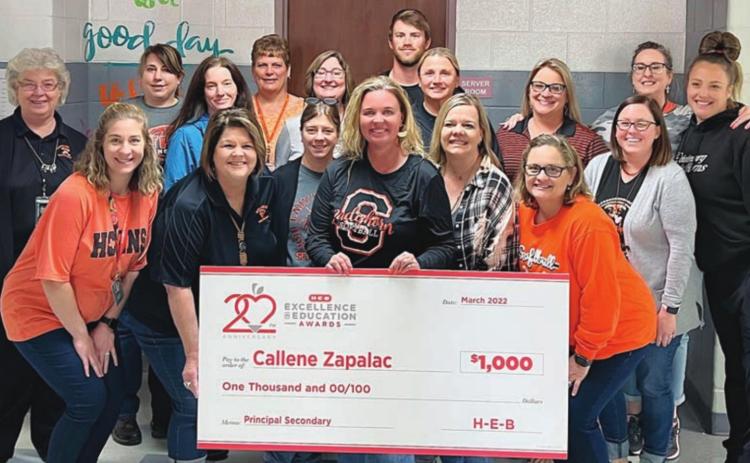 Junior High teachers and staff on hand to congratulate Principal Callene Zapalac (front, holding check) after notification came that she was a finalist for the H-E-B Excellence in Education award were: (middle, from left) Kayla Willey, Rhonda Walters, Michelle Beyer, Amy DeMarco, Kim Wellborn, Megan Zapalac; (back, from left) Jeraline Wick, Melissa Adcox, Jennifer Knigge, Donna Janda, Sharon Jochen, Wesley Kutac, Melissa Zapalac, Heather Pavlu, Amy Brenner, and Lindy Lantelme.