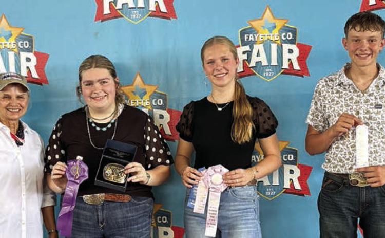 Overall High Point Seniors – (from left) buckle sponsor Elaine Thomas, in memory of Emil Thomas; Rheagan Karisch of the Pure Country 4-H, first; Madison Markwardt of the Round Top-Carmine 4-H, second; and Holden Holub of the Schulenburg 4-H, third.