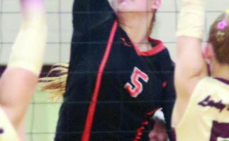 Haylee Vacek goes up high to send down one of her 30 kills against Hallettsville. Sticker Photo By Darrell Vyvjala