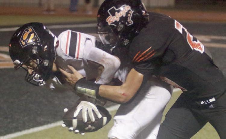 Denver Carr drags a Bobcat to the end zone after a fourth-quarter reception for the Horns’ first touchdown of 2026. Sticker Photo By Darrell Vyvjala