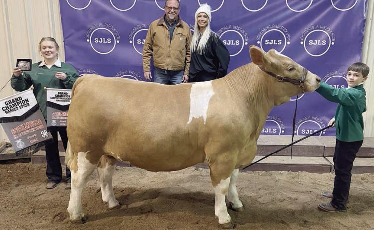STEER – Exhibitor: Crockett Guenther (right). Weight: 1,430 pounds. Sales price: $10,000. Sticker Photo By Darrell Vyvjala