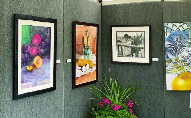Top photo – A booth with artwork by Allyson Hoffman.