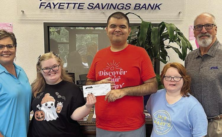 Fayette Savings Bank recently presented a $500 donation to And Then in support of the nonprofit organization’s upcoming Game Day Giveback fundraiser. Shown are (from left) Cheryl Brossmann, Fayette Savings Bank; Preslie Foster, Nicholas Romas and Brooke Shimek, And Then crew members; and Mike Olle, Fayette Savings Bank. And Then extends its appreciation to Fayette Savings Bank for investing in meaningful opportunities for young adults with learning challenges.