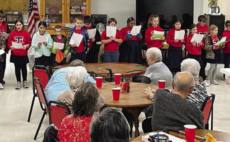 St. Rose students (standing in back) performed jokes, skits and songs for the Senior Connections Thanksgiving luncheon on Wednesday, Nov. 16.
