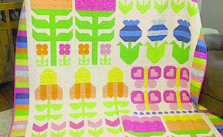 Steve Kana from Schulenburg was the 2026 winner of the drawing for a quilt at the Colorado Valley Quilt Guild’s “Best Little Quilt Show in Texas,” held on Friday and Saturday, Feb. 27-28 at the KC Hall in La Grange. Carol Kana pictured with the “Flower Power” quilt.