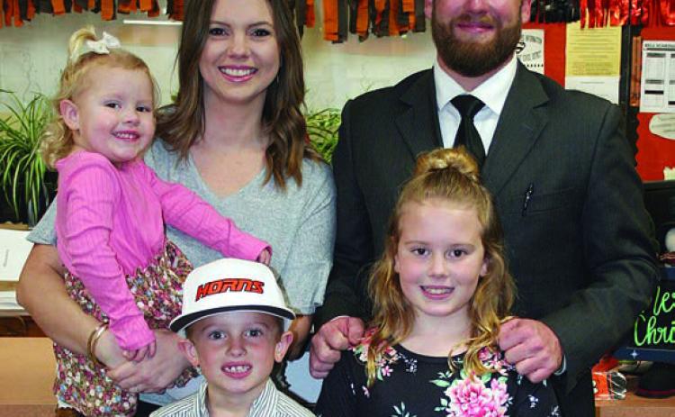 On hand at Monday night’s school board meeting to accept the SISD athletic director position was Luke Hobbs with his wife, Savannah, and children (from left) Sadie, Shane, and Presley. Sticker Photo By Darrell Vyvjala