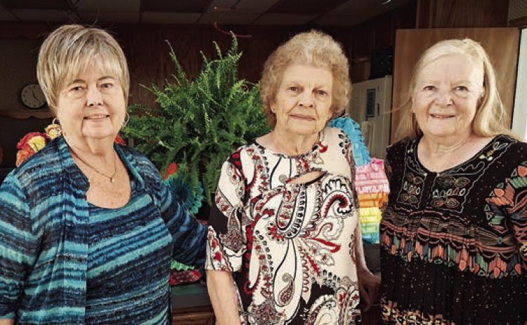 Hostesses were (from left) Bonnie Baker, Jerry Leonard and Janet Murphy.