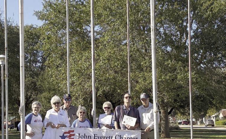 DAR and SAR representatives with a banner for flag display recognition, which was awarded to Dale and Doreen Alexander for December, are (from left) Donna Pustejovsky, Connie and Vernon Dittrich, Nelma Strey, Judy Zachmeyer, Glen Strey and David Zachmeyer