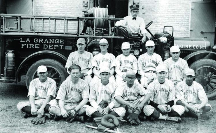 The La Grange Fire Department’s baseball team poses in front of an early fire engine and the Old Casino Hall, which had recently been converted from La Grange High School to a fire station. None of the men have been identified.