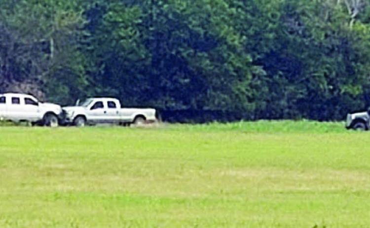 Members of the Austin County Regional Special Response Team approach the stolen vehicle and trailer. Photo Courtesy of the Fayette County Sheriff’s Department