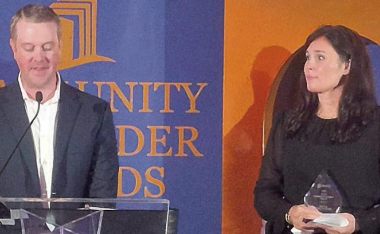 COMMUNITY IMPACT AWARD – Senior Connections. Executive Director Amanda Kridel (right) accepts the award, presented by Fayette Savings Bank President Wade Mozisek (left). Photo Special to the Sticker By Scott Wenske