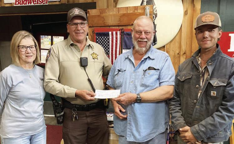 For “Make a Difference Day,” Hermann Sons Schulenburg Lodge 14 presented a monetary gift to the Fayette County Deputy Santa program. Shown are (from left) lodge vice president Mary K. Seifert, Deputy Terry Guentert, lodge president Ed Moeller and member Joshua Roberts.