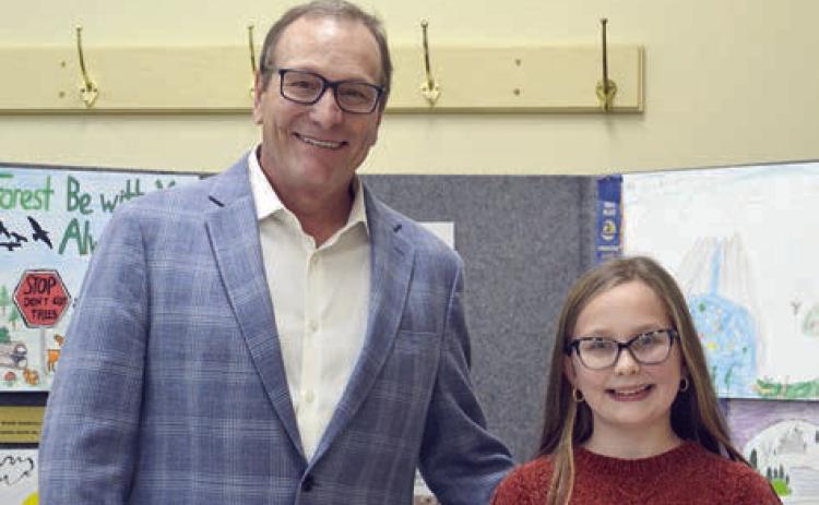 ESSAY CONTEST winners in the age 13 and under division were Charli Hadaway (right) of Sacred Heart School in La Grange and Bree Dooley (not shown) of Round Top-Carmine High School. Presenter was Tim Knesek (left) of Capitol Farm Credit.