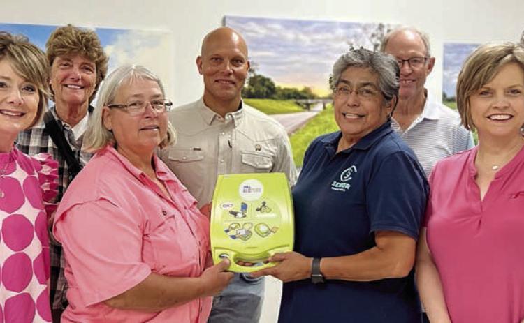 AN Automatic External Defibrillator (AED) was delivered on July 27 in conjunction with the Senior Connections board meeting. Shown at the presentation are (front row, from left) Tami Walker, city administrator; Mayor Connie Koopmann, handing the AED to Cindy Villarreal, Senior Connections executive director; Jennifer Moring of Fayette Savings Bank; (back row) Linda Kobersky; Chip Bubela, board chair; Bob Stanzel, board treasurer; and City Alderman Clarence Ahlschlager.